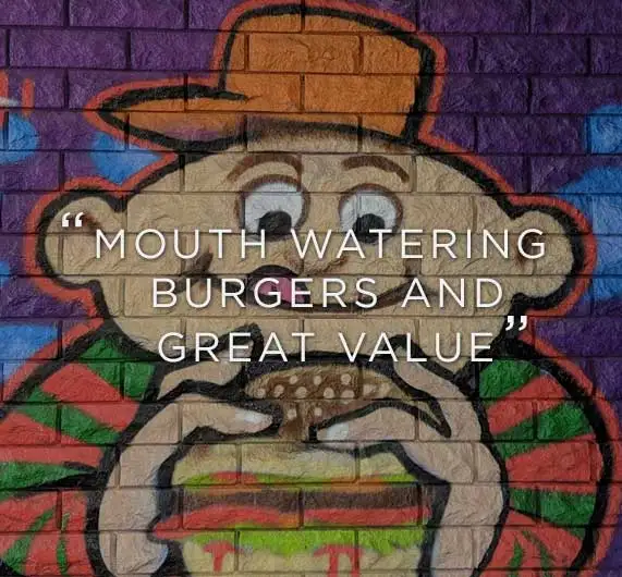 Sneaky Burger mural painted on a brick wall in Wollongong