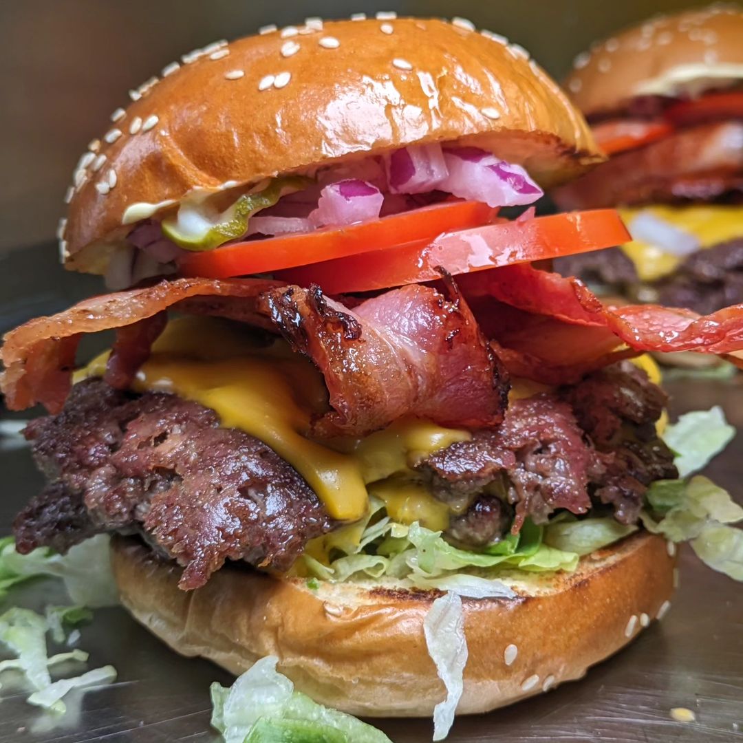 Double-decker wagyu burger with cheese and red onion